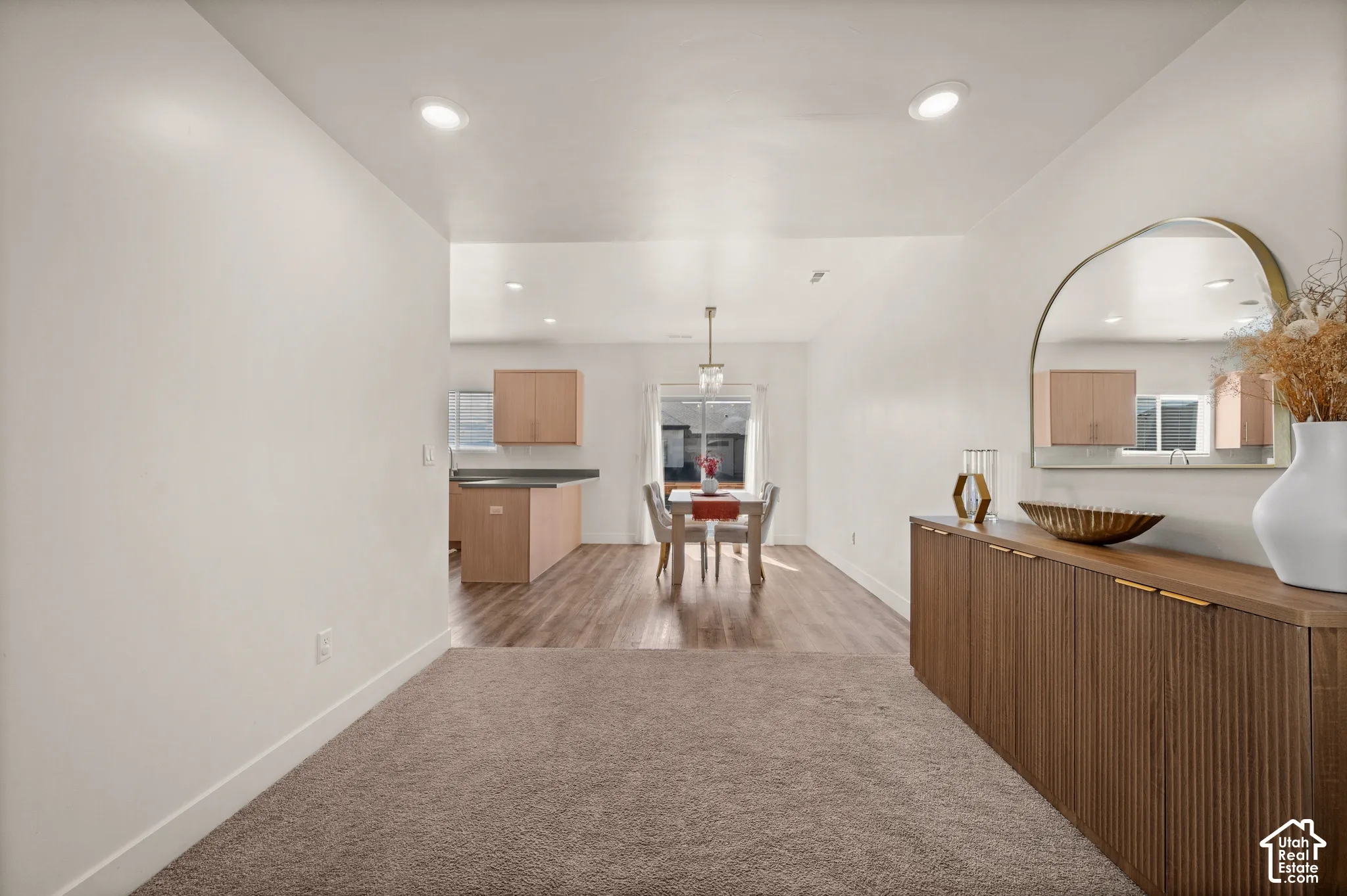 Recessed lighting, wood-finish flooring, and light-toned walls