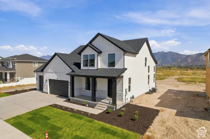 Modern farmhouse-style exterior with white siding and black trim