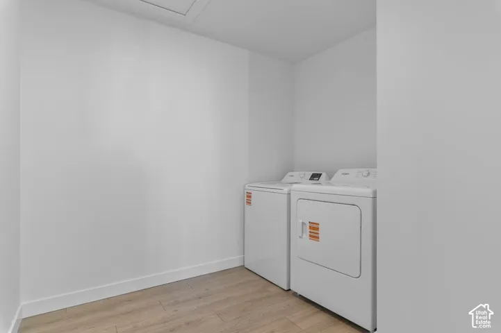 Appliance hookups with side-by-side units and wood-finish flooring