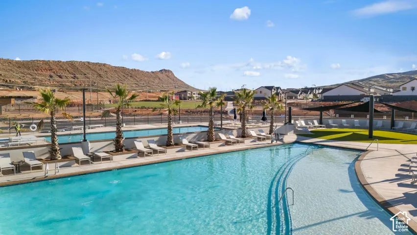 Expansive aquatic amenity featuring a large swimming pool, a shallow sun shelf, and a dedicated lap pool