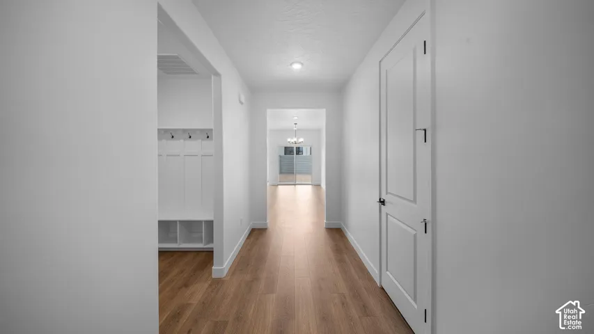 Entryway mudroom featuring built-in white cabinetry, coat hooks, and integrated storage cubbies