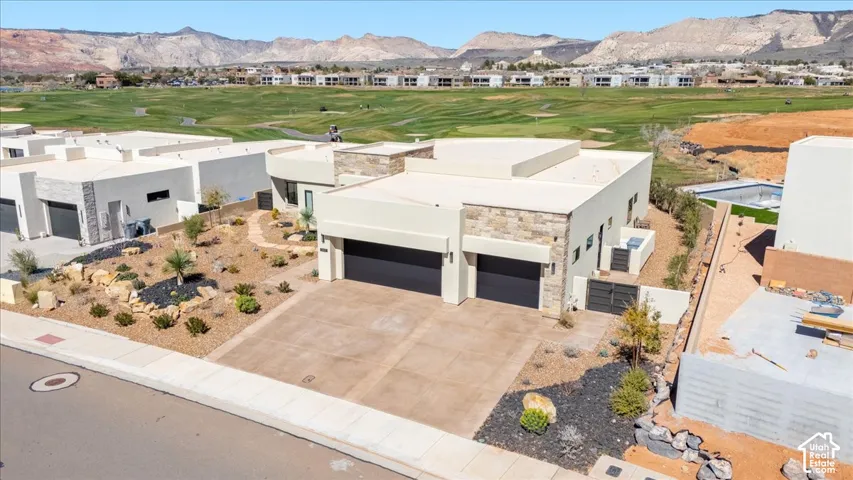 Contemporary exterior with a flat roofline, stone accent walls, and a two-car garage