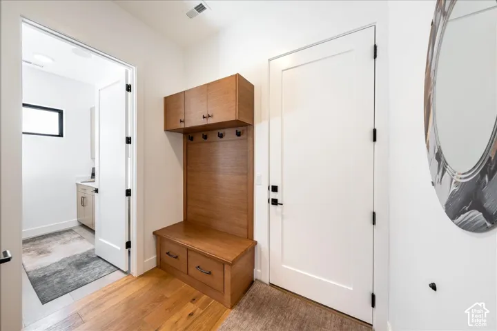 Built-in wood-finish cabinetry and bench with integrated storage drawers
