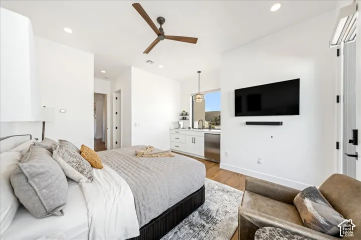 Recessed lighting, wood-finish flooring, and a contemporary ceiling fan