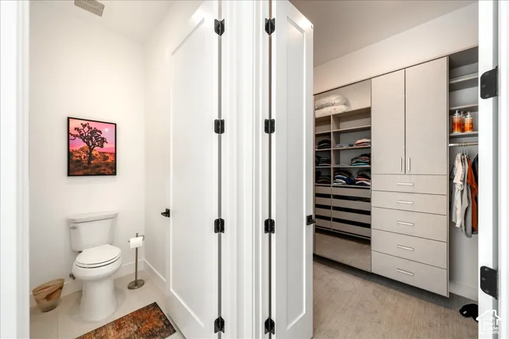 Built-in custom closet system with varied shelving, drawers, and hanging storage