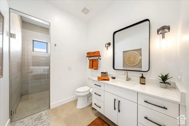 Glass-enclosed shower with tiled walls and a small window