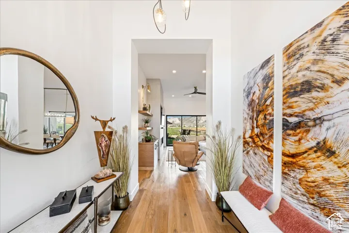 Hardwood flooring, recessed lighting, and modern pendant light fixtures