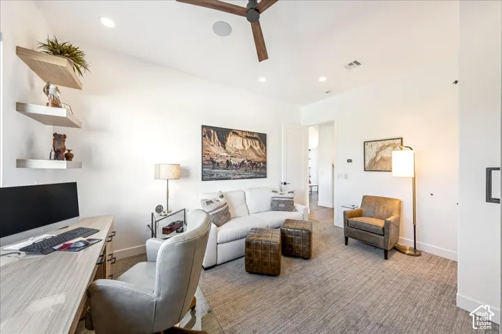Recessed lighting, a ceiling fan with wood-finish blades, and built-in floating shelves