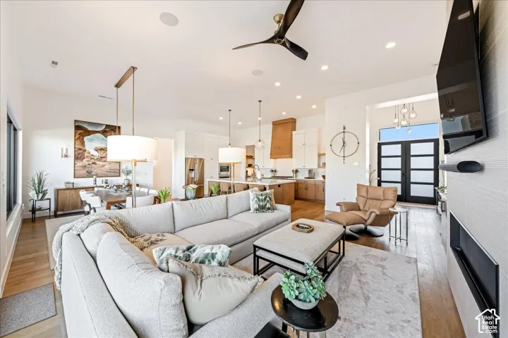 Open-concept living space featuring wood-finish flooring, recessed lighting, and a modern ceiling fan