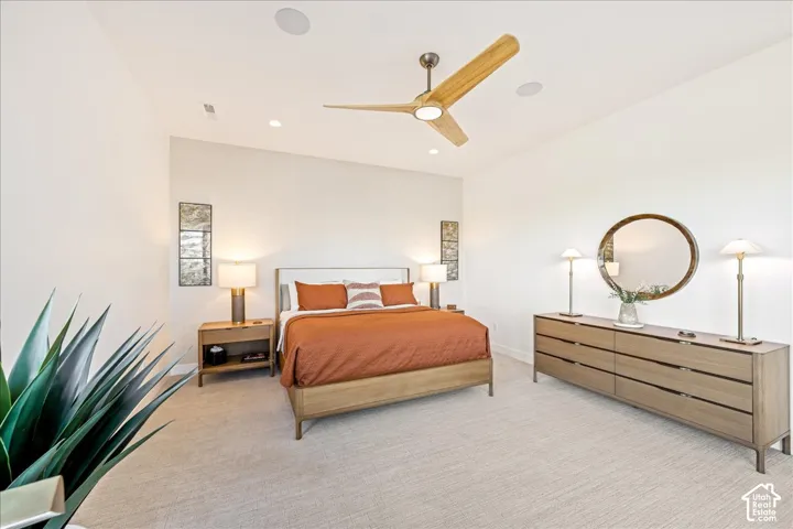 Recessed lighting, ceiling-mounted speakers, wood-blade ceiling fan, and carpeted flooring