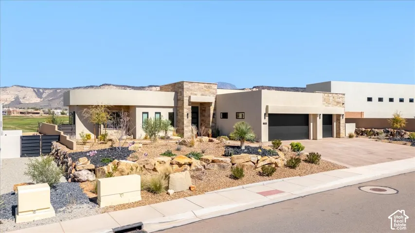 Contemporary exterior with stucco finish and stone accents