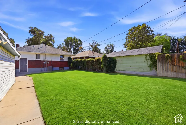 Spacious lawn area with mature perimeter foliage