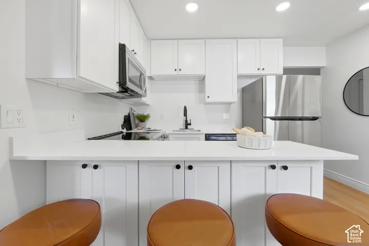 Quartz countertops, shaker cabinets and stainless steel appliances