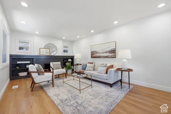 Spacious living room with new floors and a cozy fireplace.