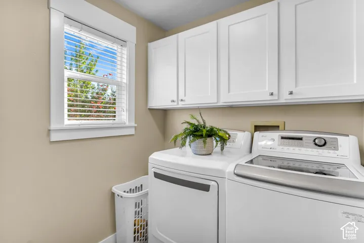 Upper white cabinetry with brushed nickel hardware