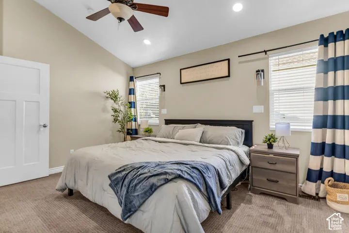 Vaulted ceiling featuring a ceiling fan with integrated lighting, recessed lighting, and twin windows with blinds