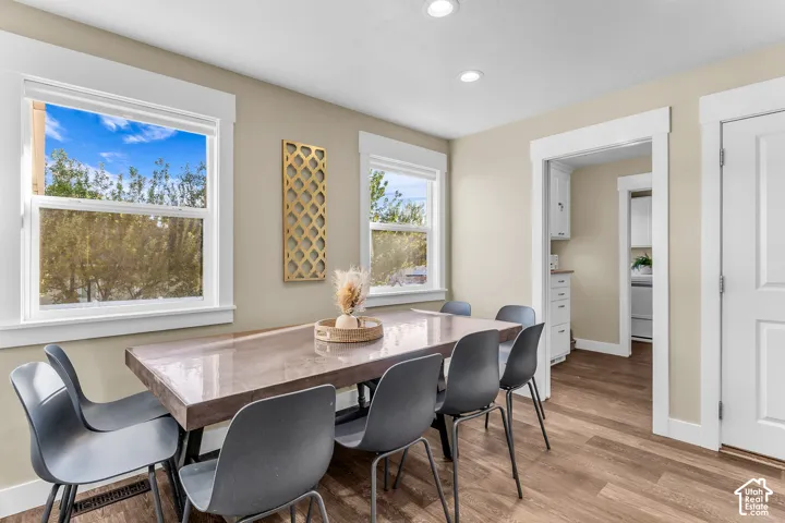 Recessed lighting, wood-finish flooring, white trim, and light-toned walls