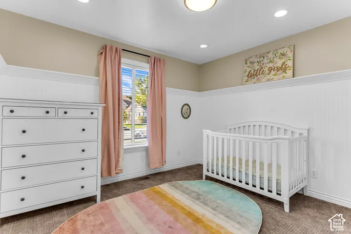 Recessed ceiling lighting, a window with exterior views, and wainscoting details