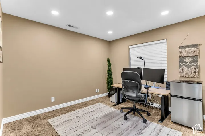 Recessed ceiling lighting, neutral wall tones, window with blinds, and carpeted flooring