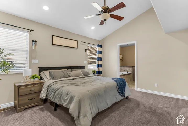 Vaulted ceiling with a ceiling fan, recessed lighting, and wall sconces