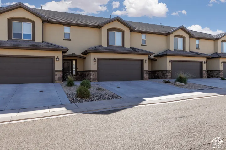 Stucco exterior featuring stone accents and arched window details