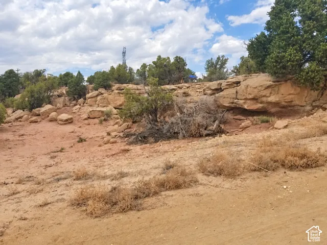 Natural desert terrain featuring rock formations and scattered brush