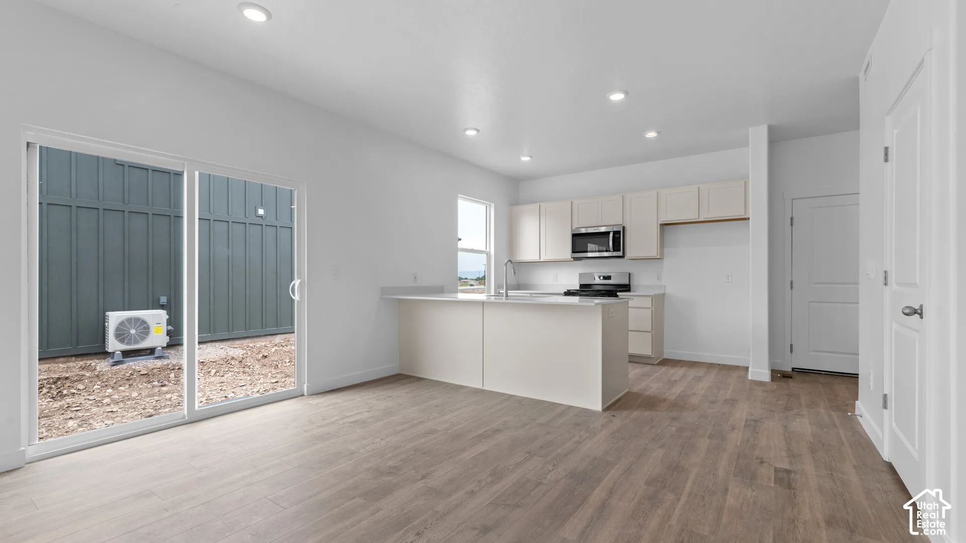 Open-concept living space with wood-finish flooring