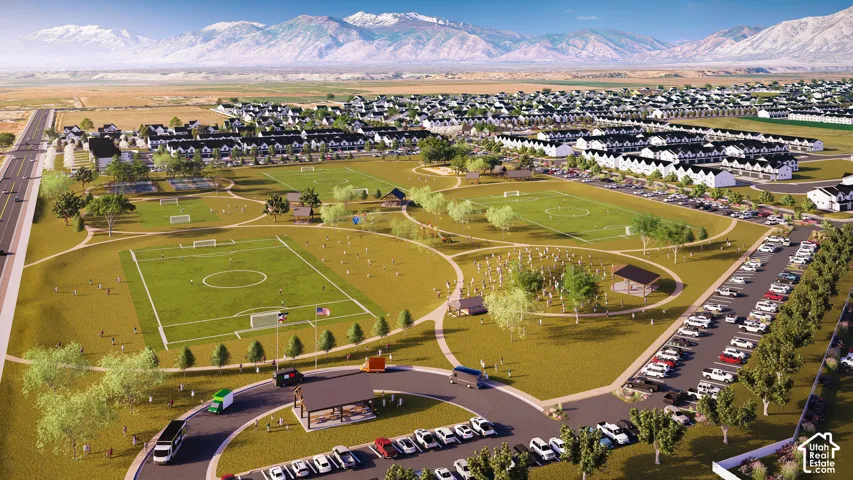 Expansive community grounds featuring sports fields, paved pathways, and open green spaces