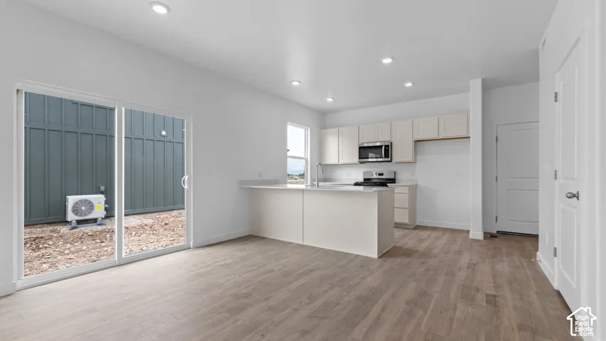 Open-concept living space with wood-finish flooring