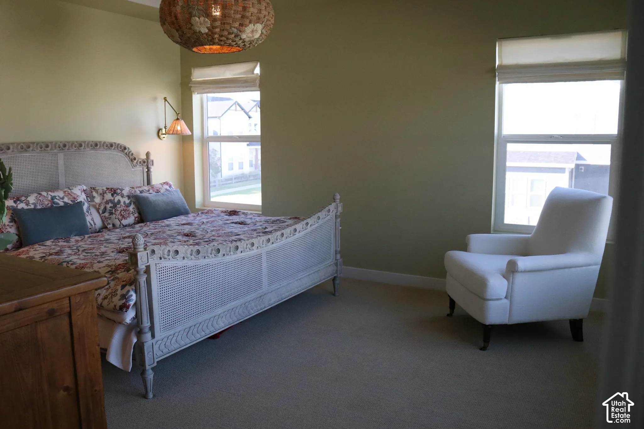 Textured wall sconce, light green wall finishes, and a woven ceiling light fixture