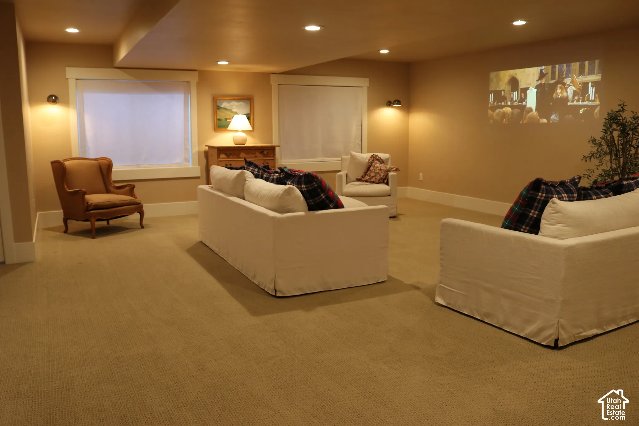 Recessed lighting, wall sconces, two windows, wall-mounted projection