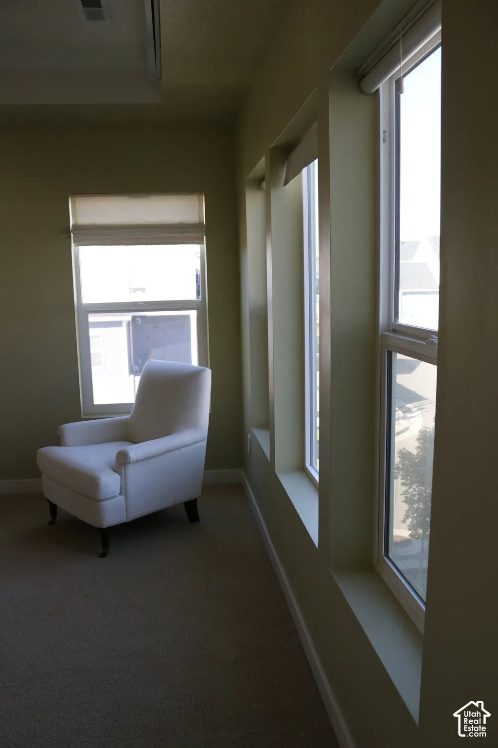 Multiple large windows, a single window, and light-colored walls