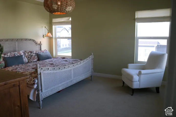 Textured wall sconce, light green wall finishes, and a woven ceiling light fixture