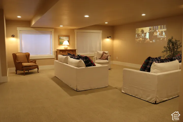 Recessed lighting illuminates a carpeted floor and painted walls