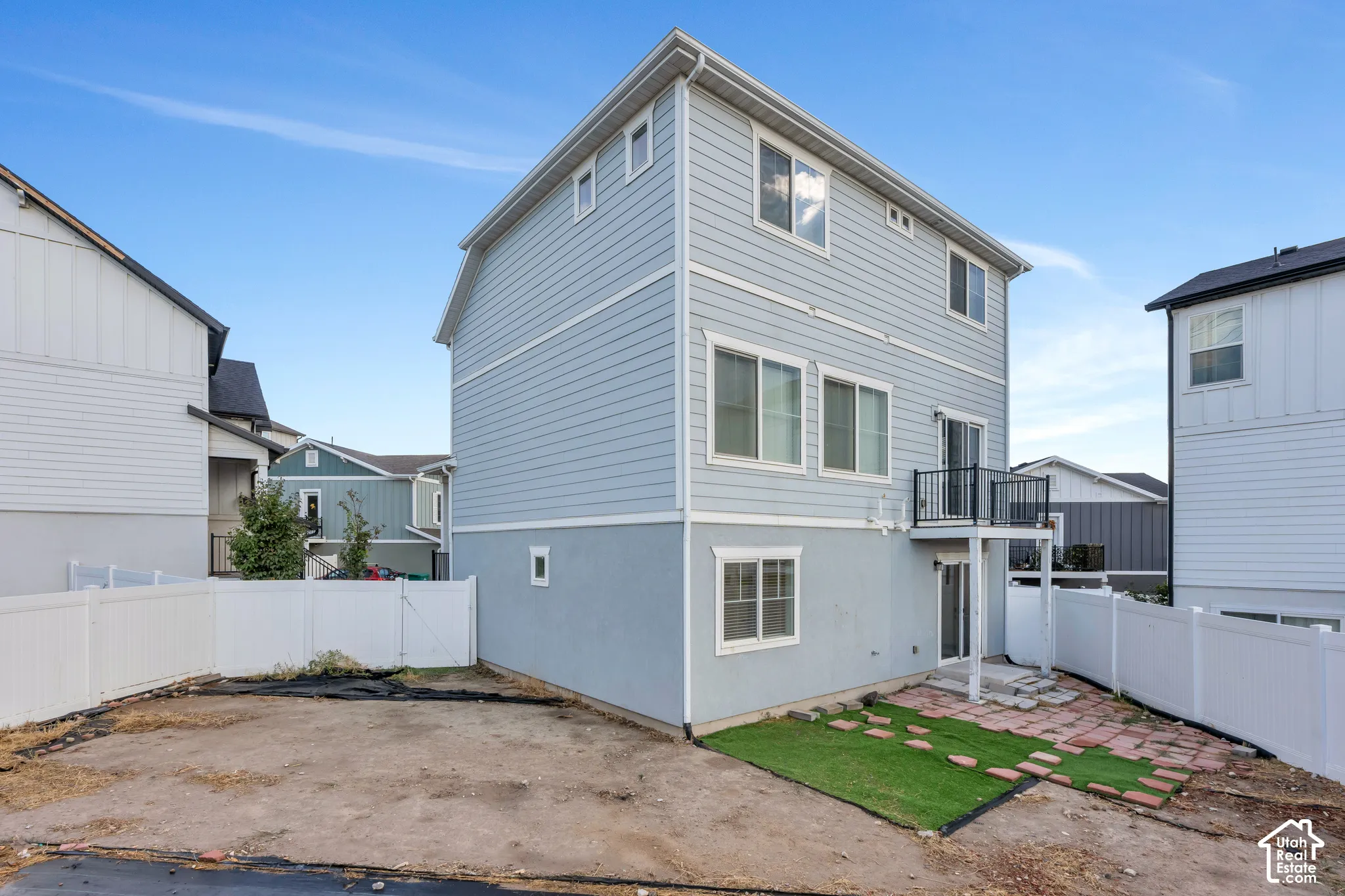 Light blue siding exterior with a lower level stucco finish