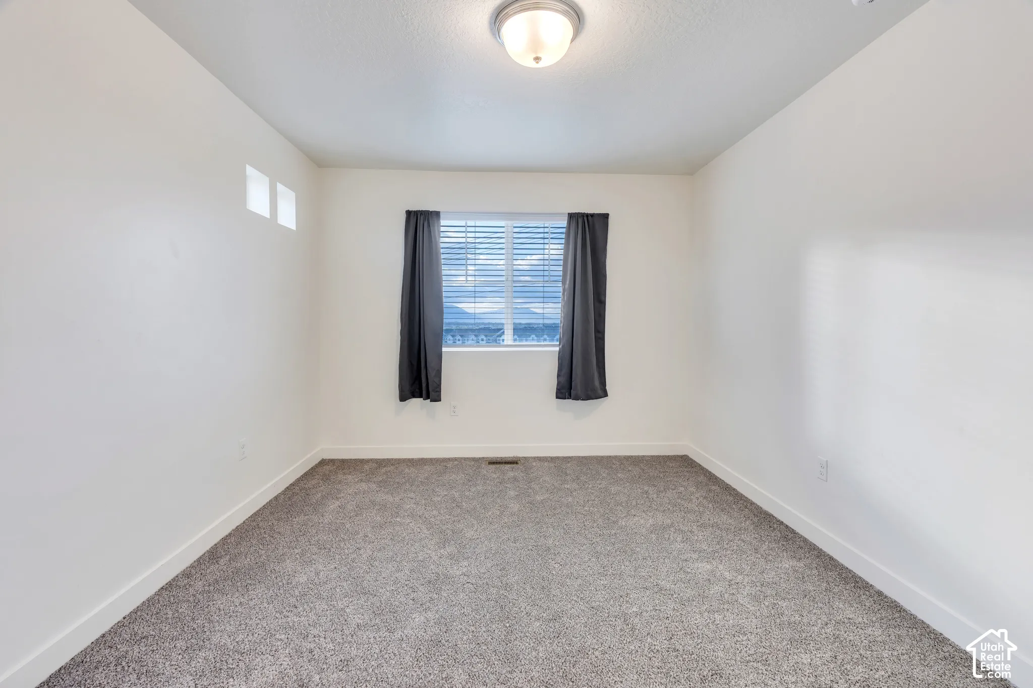 Recessed window with blinds, overhead flush mount light fixture, and two high wall windows