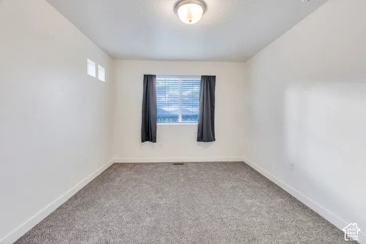 Recessed window with blinds, overhead flush mount light fixture, and two high wall windows