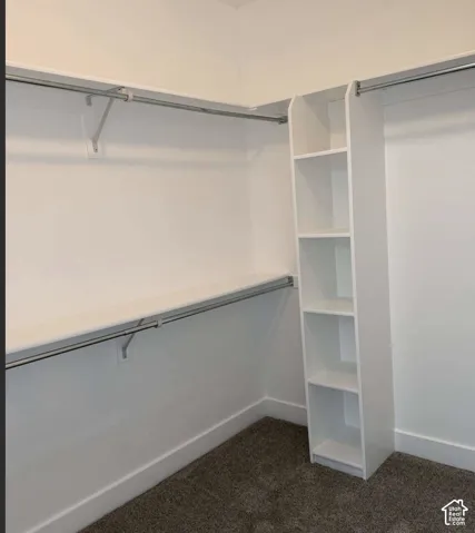 Built-in shelving unit with multiple shelves, white wire shelving, and hanging rods