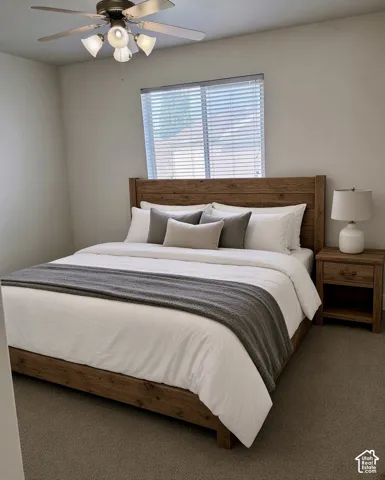 Wall-to-wall carpeting and a ceiling fan with integrated lighting