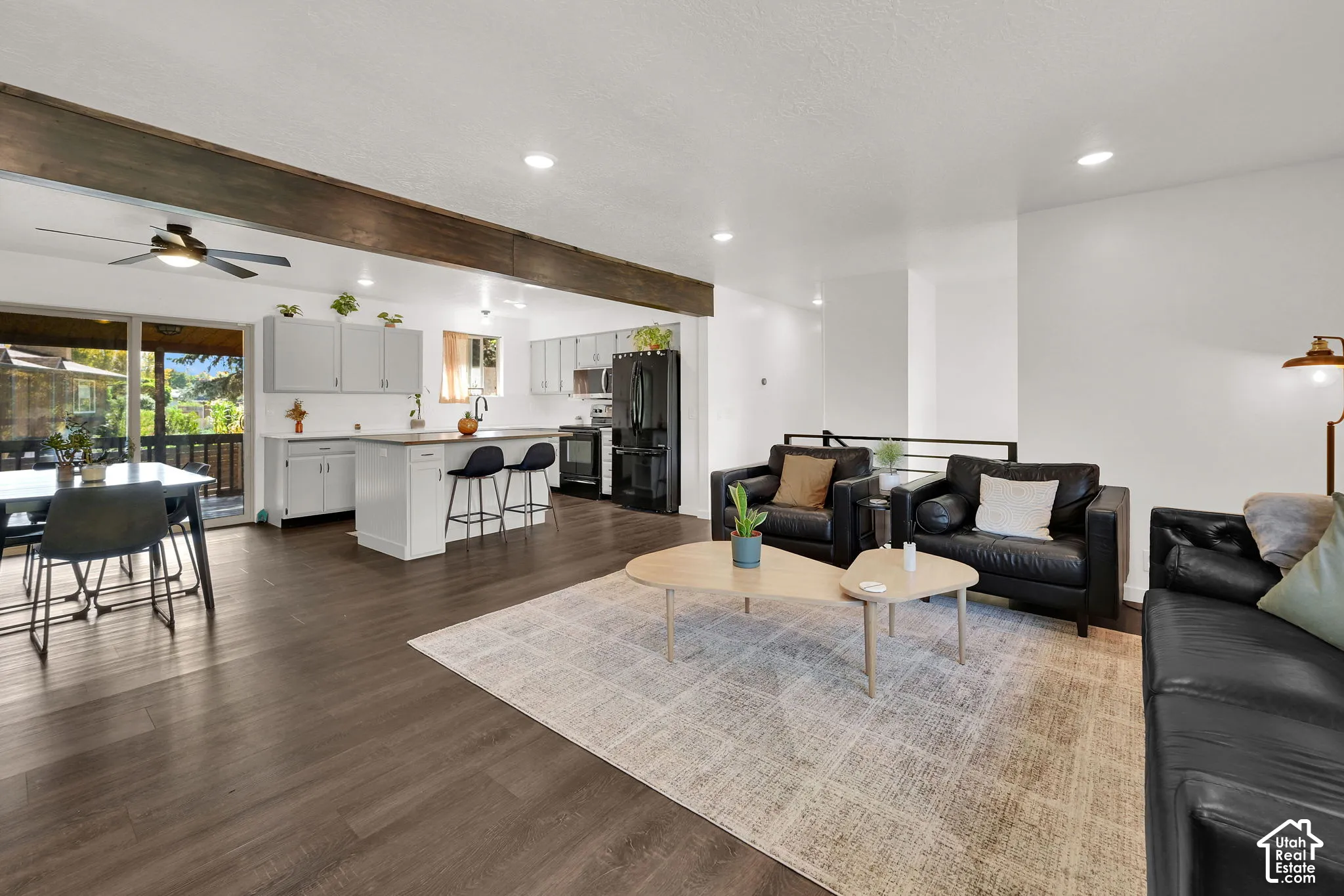 Open-concept living area with dark wood-finish flooring