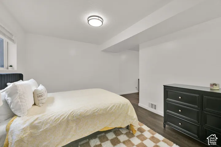 4th bedroom with wood-finish flooring with white baseboards