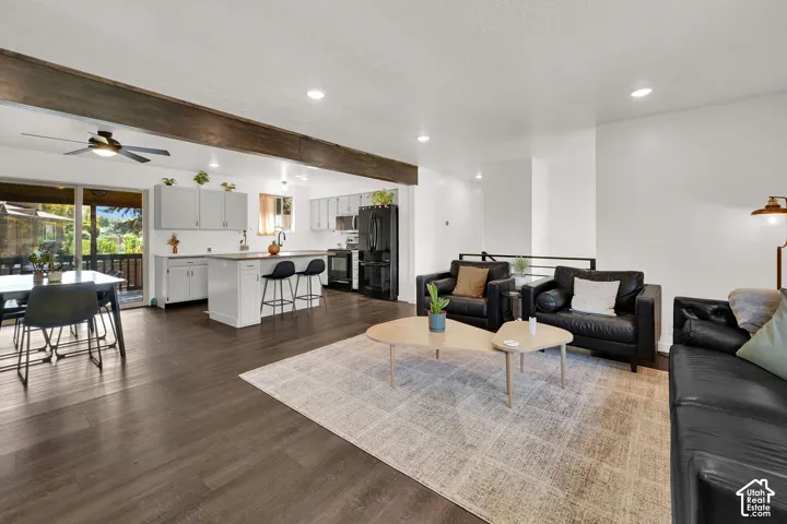 Open-concept living area with dark wood-finish flooring