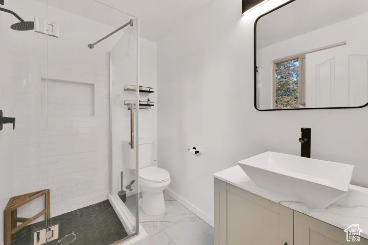Main bedroom ensuite with walk-in shower with subway tile surround and dark hexagonal floor tile