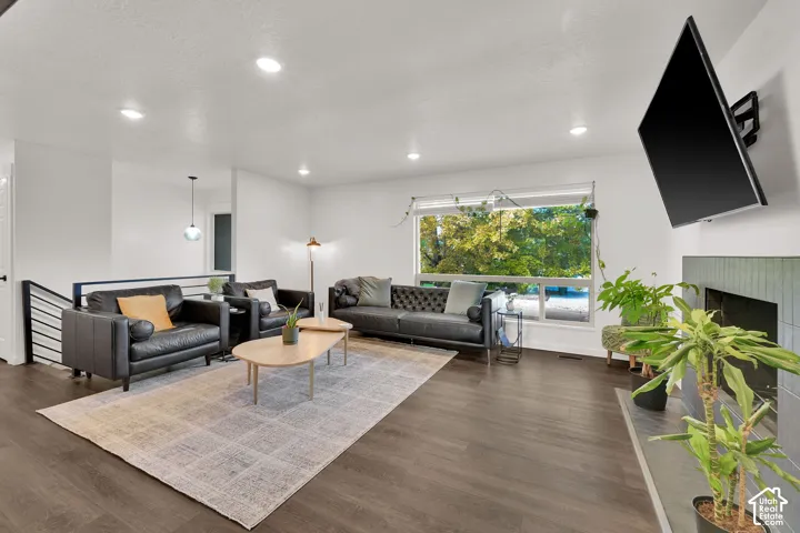 Spacious living area featuring wood-finish flooring, recessed lighting, and a large window