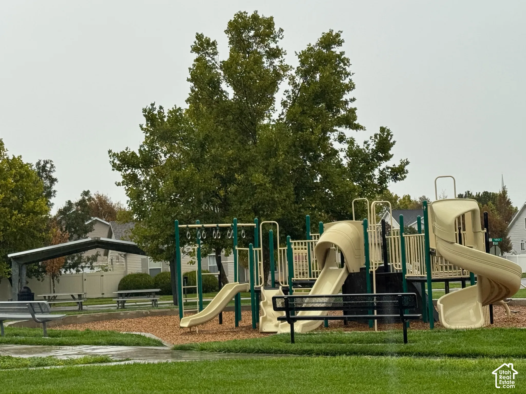 Playground area featuring multiple slides, swing sets, and a climbing structure
