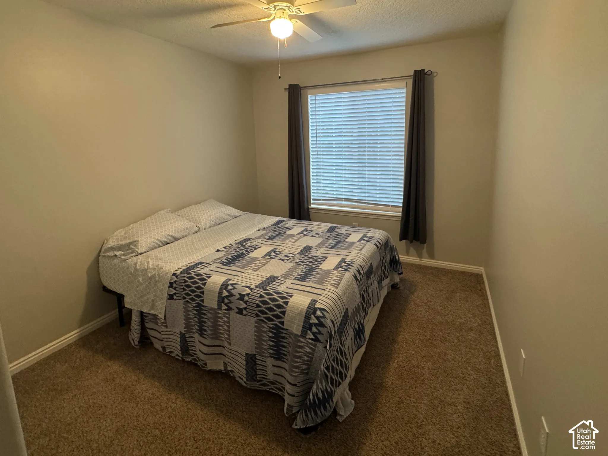 Bedroom 2 Carpeted room featuring a ceiling fan with integrated lighting, window with blinds, and neutral wall tones