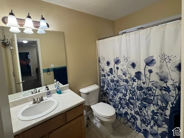 Floor 2 Second Bathroom: Single vanity with an integrated sink and wood-finish cabinetry