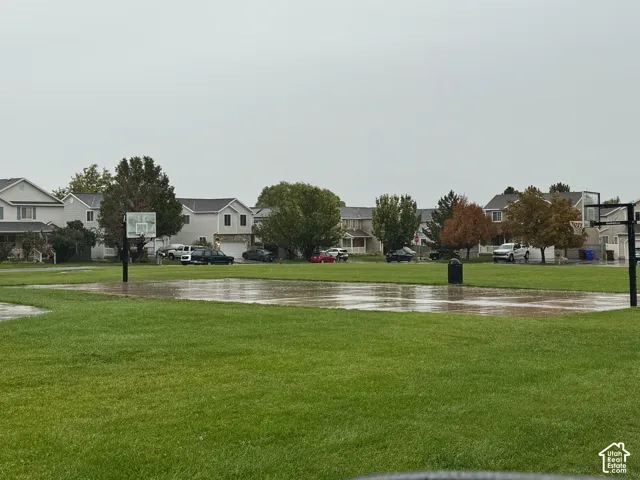 Expansive green space featuring a basketball court with two hoops