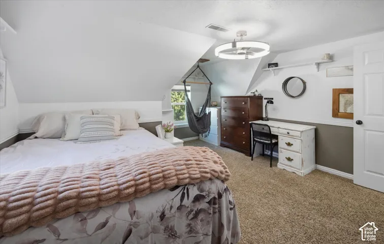 Sloped ceilings, built-in shelving, and a ceiling-mounted light fixture