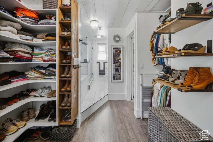 Custom built-in shelving, wood-finish flooring, and white shiplap ceiling